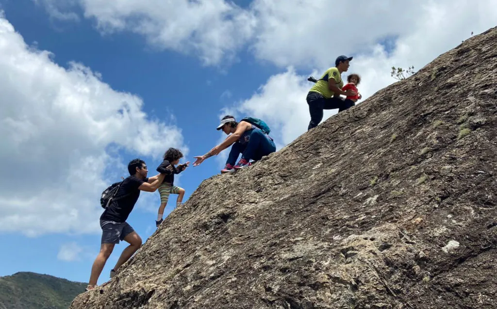 Parents and children helping each other on the trail